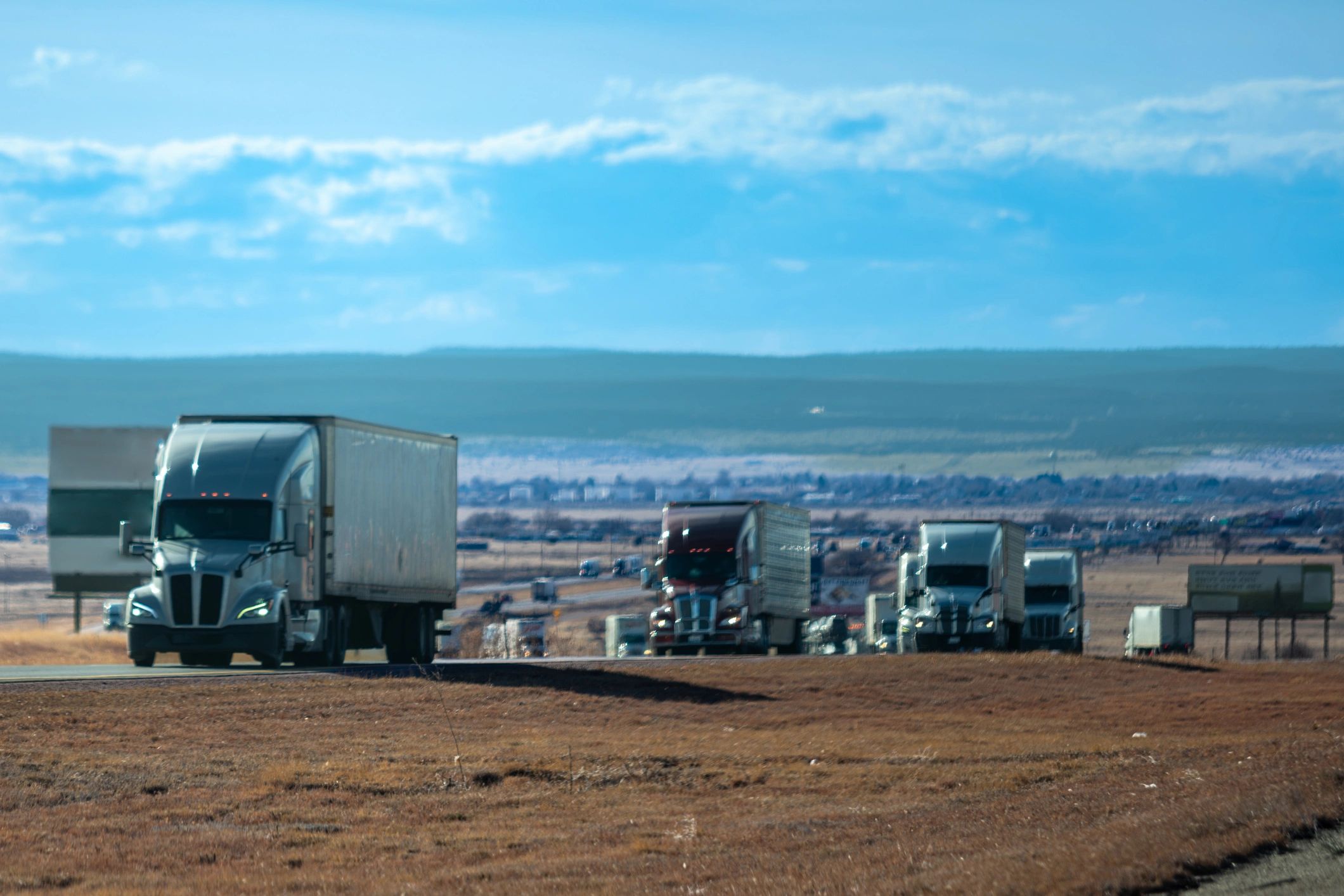 Commercial trucks lined up in an open operations yard
