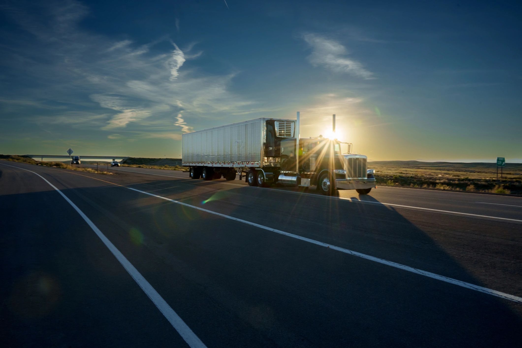 Blue semi-truck operating on an open highway